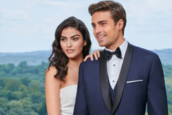 Man in tuxedo next to woman